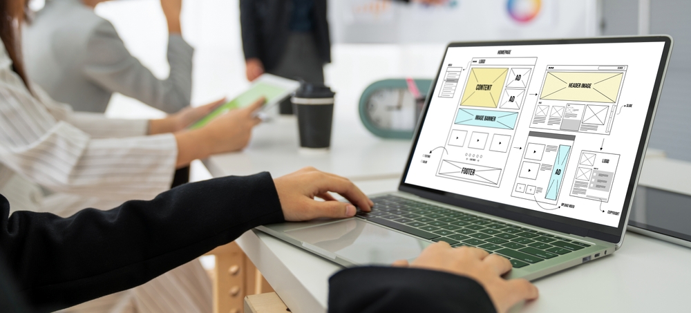 The Cost of Website Design in Phoenix: What to Expect 2 Web designer working on a laptop
